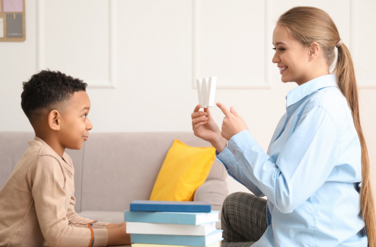 A parent using ABA therapy strategies at home with a child in Queens, NY